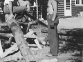 1937 Cutting Wood Near Lodge